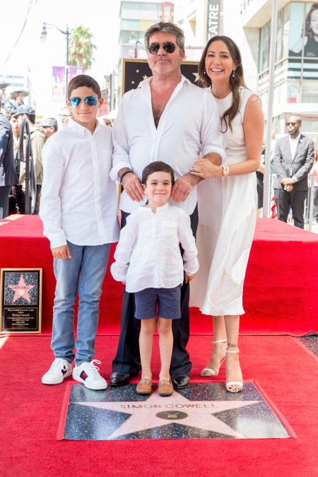 Simon Cowell, Lauren Silverman, Eric Cowell and Adam Silverman smiling in white