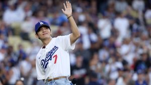 Kim Tae-Hyung, aka V of BTS, waves to the crowd prior to the game between the Los Angeles Dodgers and the Cincinnati Reds