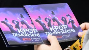 A visitor holds leaflets at a 'KPop Demon Hunters' themed zone at the Everland Resort, South Korea's largest theme park, in Yongin, Gyeonggi Province on September 30, 2025.