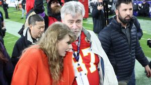 Taylor Swift is seen on the field with Ed Kelce, father of Travis Kelce #87 of the Kansas City Chiefs, after a 17-10 victory against the Baltimore Ravens in the AFC Championship Game at M&T Bank Stadium on January 28, 2024 in Baltimore, Maryland